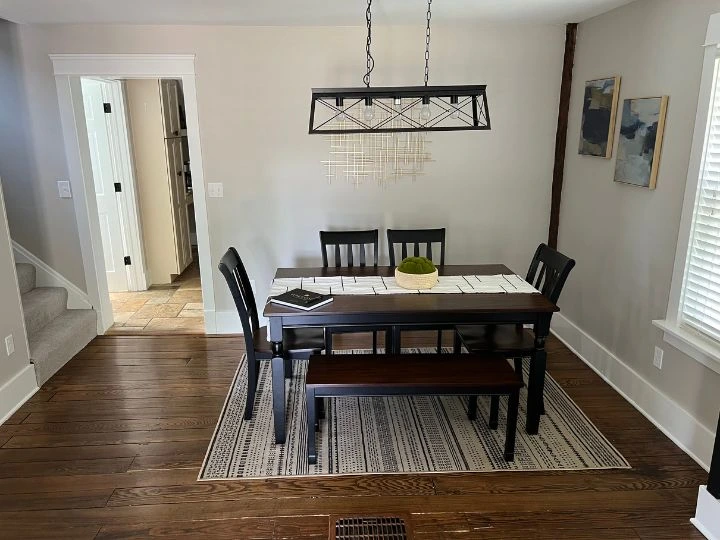 A freshly cleaned residential dining room with a polished dining table, clean chairs, and a tidy space